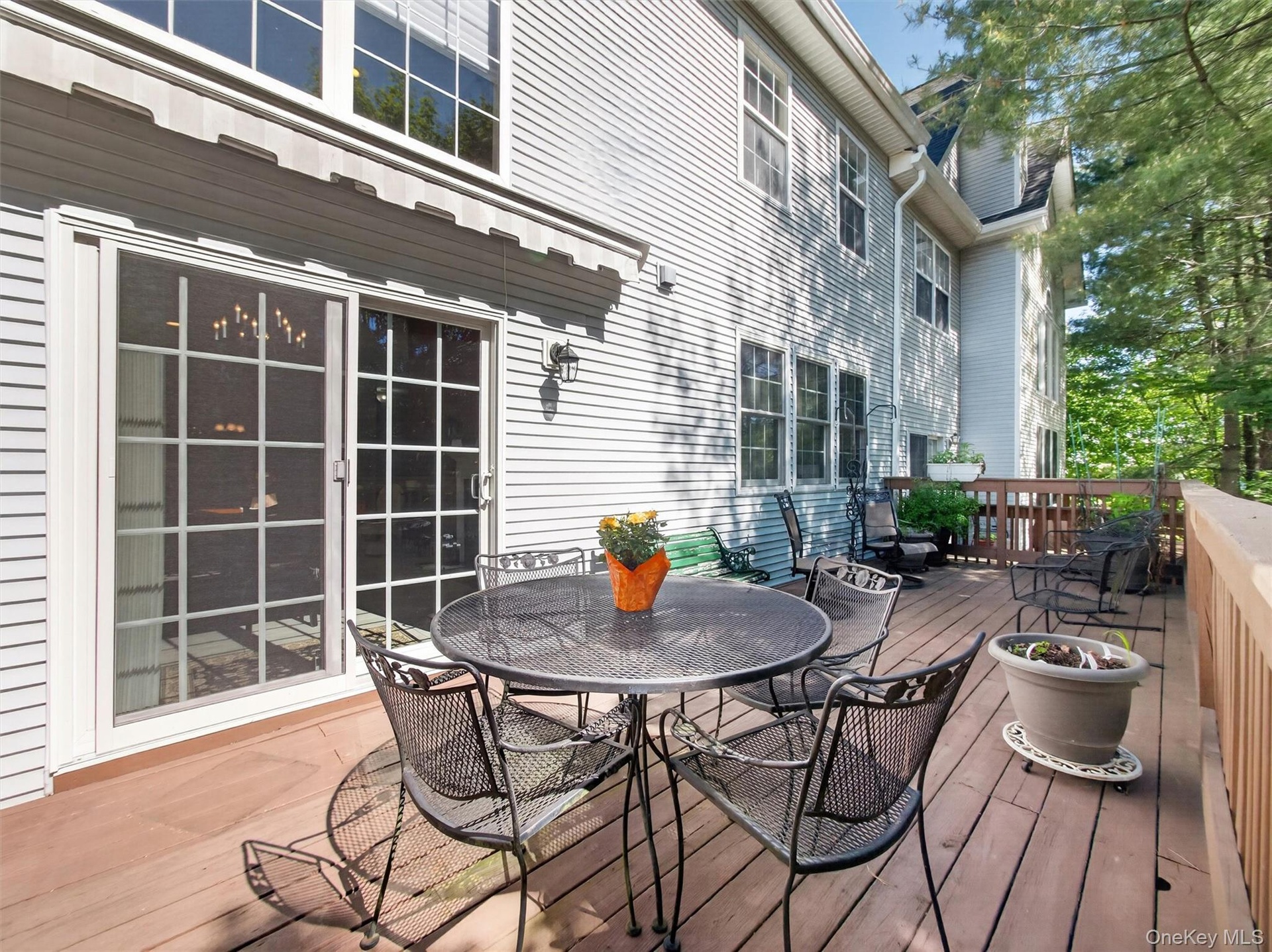 Spacious secluded deck designed for seamless entertaining.  Slider leads to formal dining room.  Newer remotely retractable awning.
