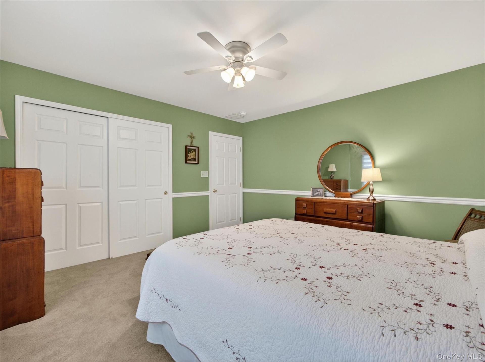 Another view bedroom 2, with double closet, chair rail, and ceiling fan.