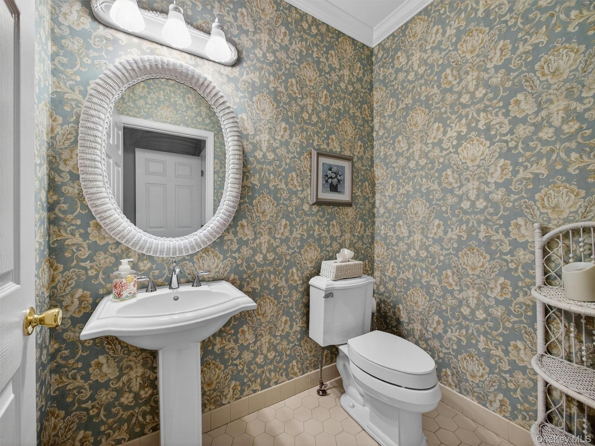 Elegant first floor powder room with wallcovering.
