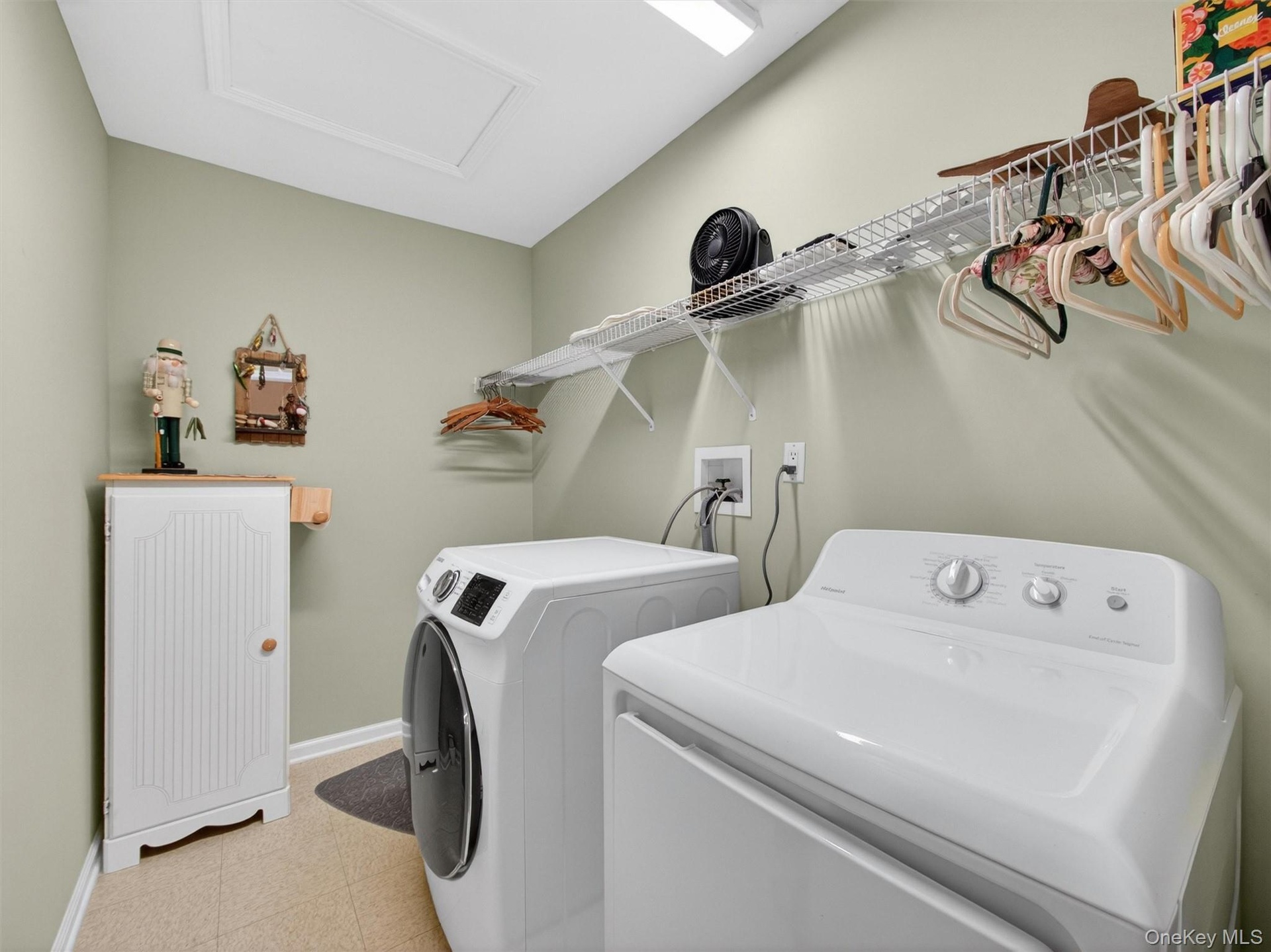 Convenient bedroom level laundry with storage shelving.