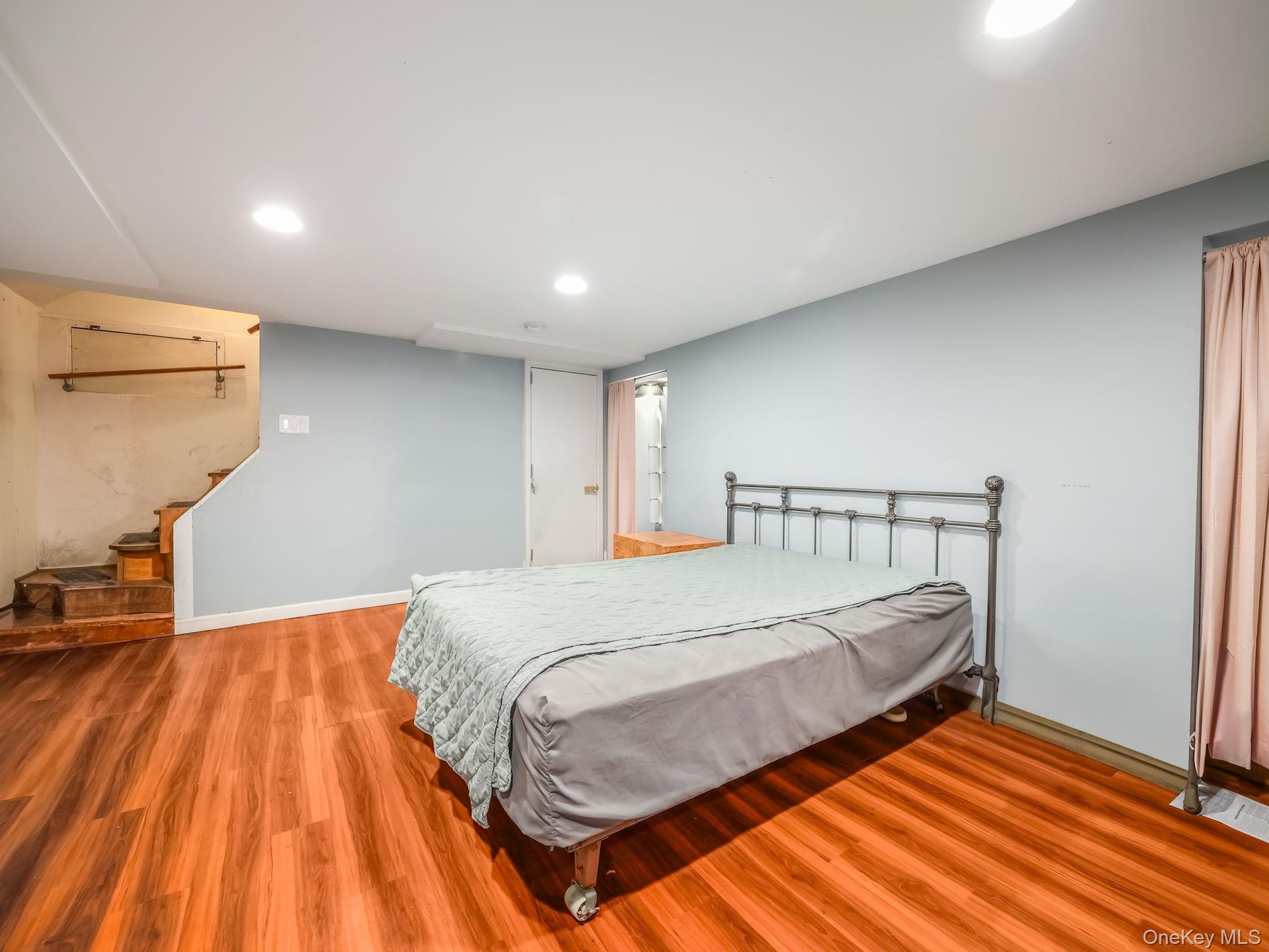 Bedroom with light wood finished floors and recessed lighting