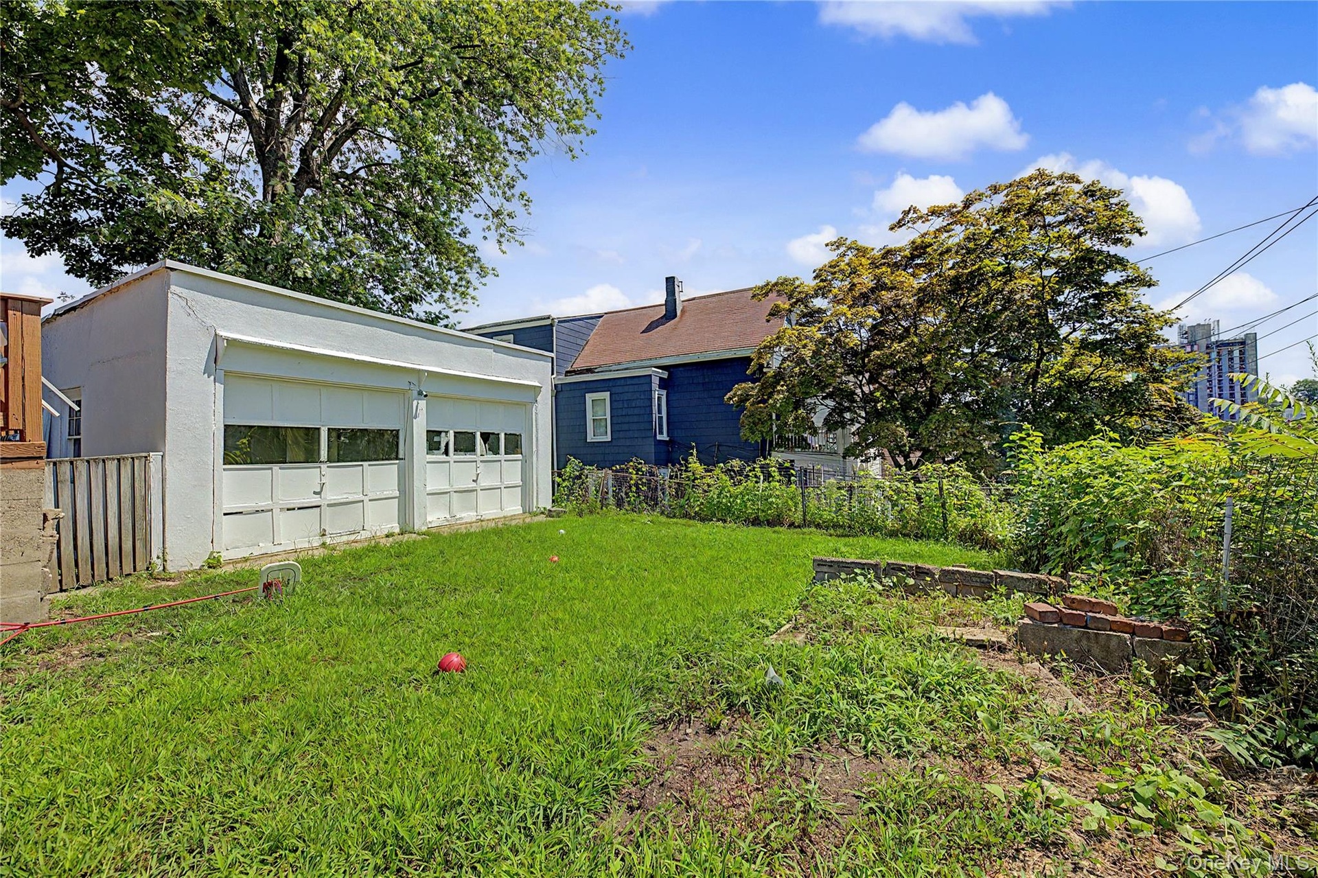 Detached two-car garage with overhead doors featuring multiple window panes