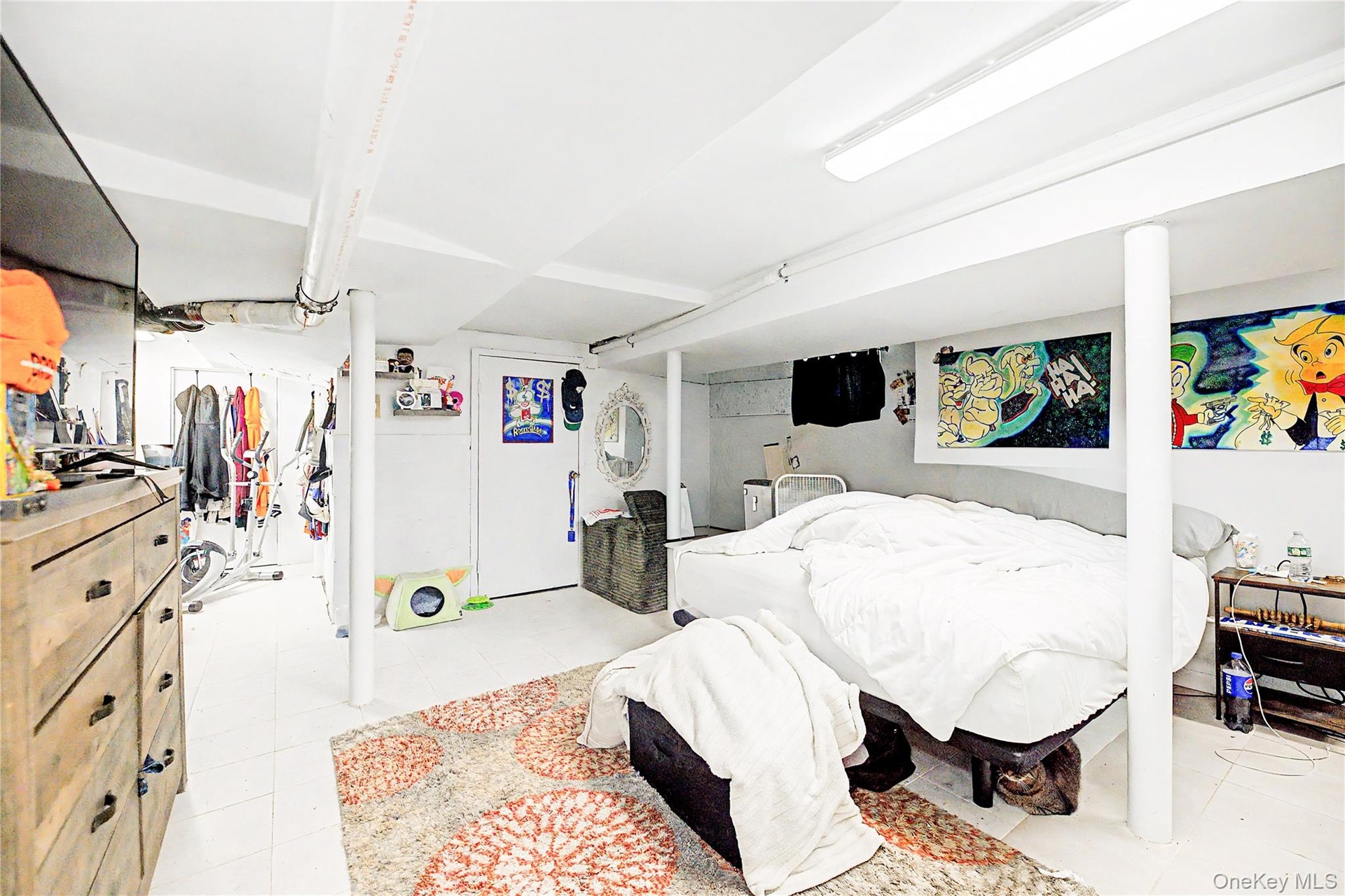 Sloped ceiling room featuring wood-finish flooring, a double window, and a flush-mount light fixture
