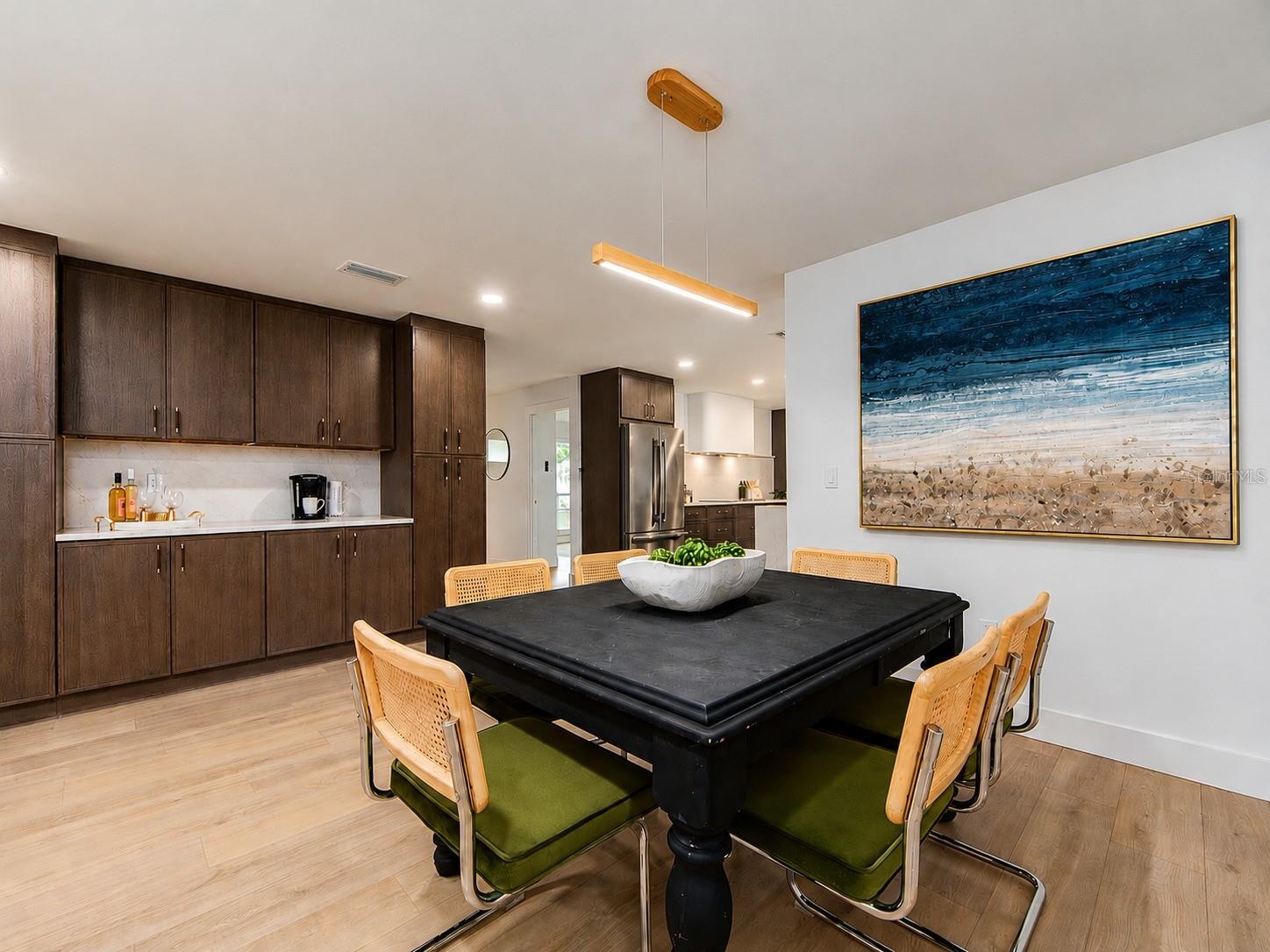 PERFECT DINING SPACE WITH COFFEE BAR/SERVING AREA, CABINETRY AND 2 PANTRIES