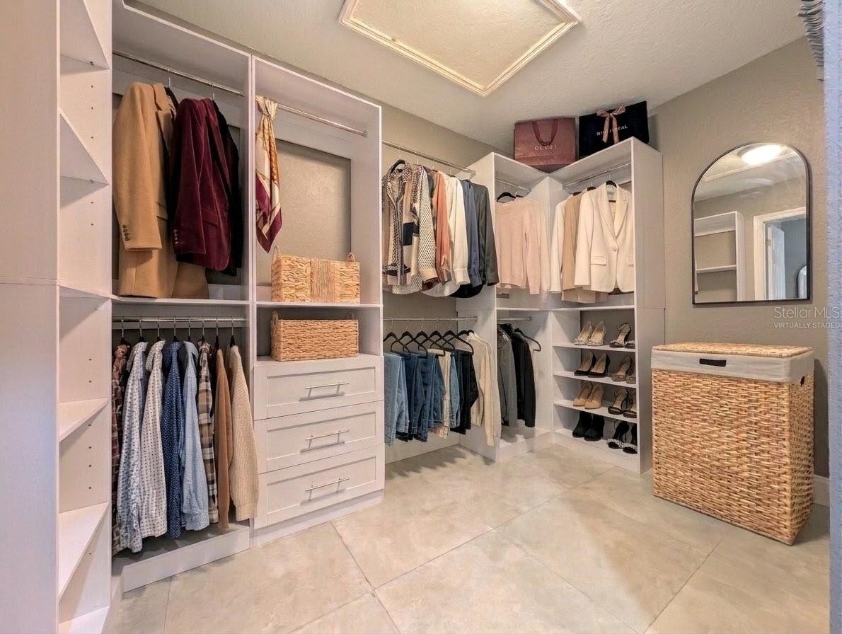 Brand new closet shelving. Virtually staged w/ clothing, hamper & mirror.