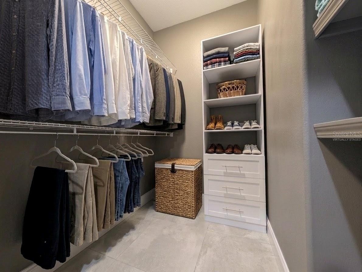 Virtually staged w/ clothing & hamper.