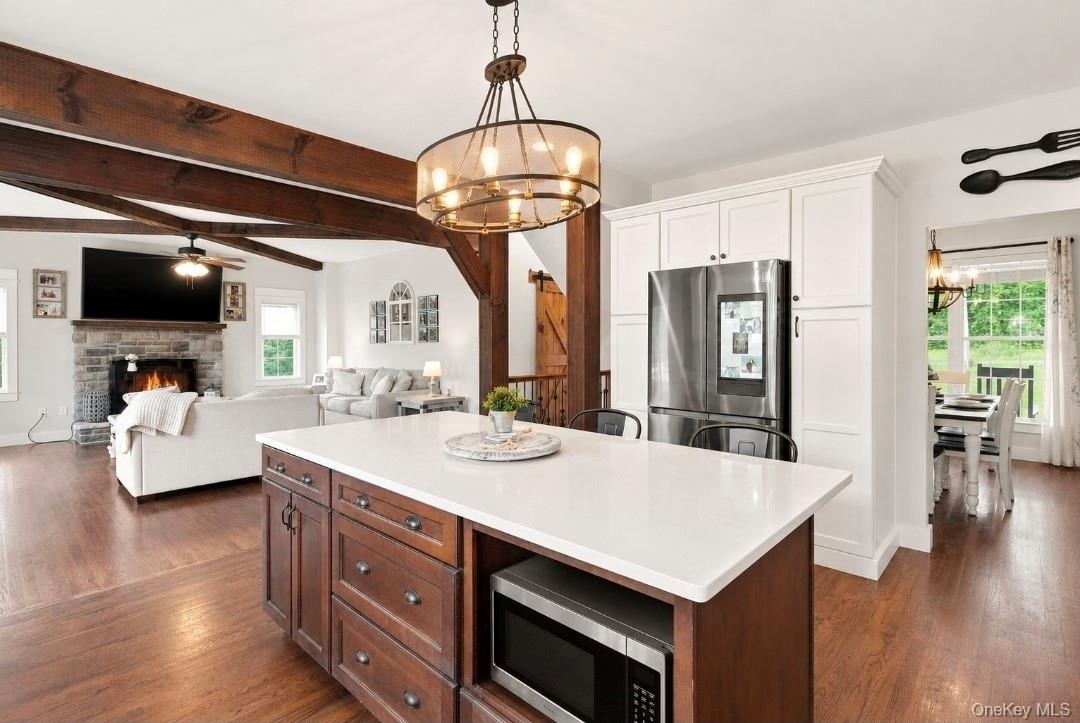 Quartz countertops and oversized island with additional storage and built in microwave