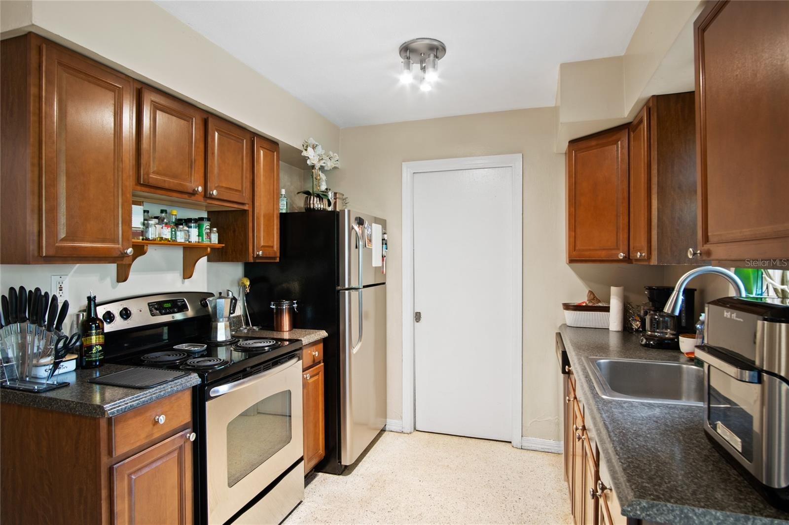 The kitchen has a range, refrigerator, and dishwasher.