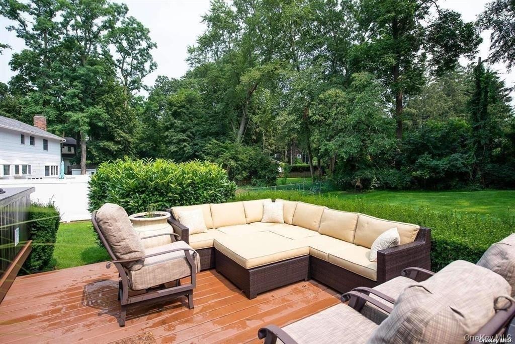 Deck with outdoor lounge area and a lawn