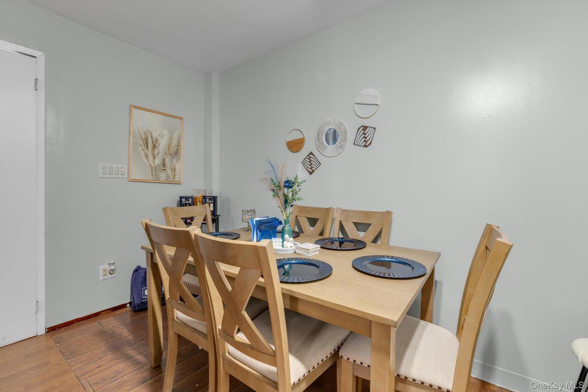 Hardwood flooring, light-toned wall paint, and a white door.