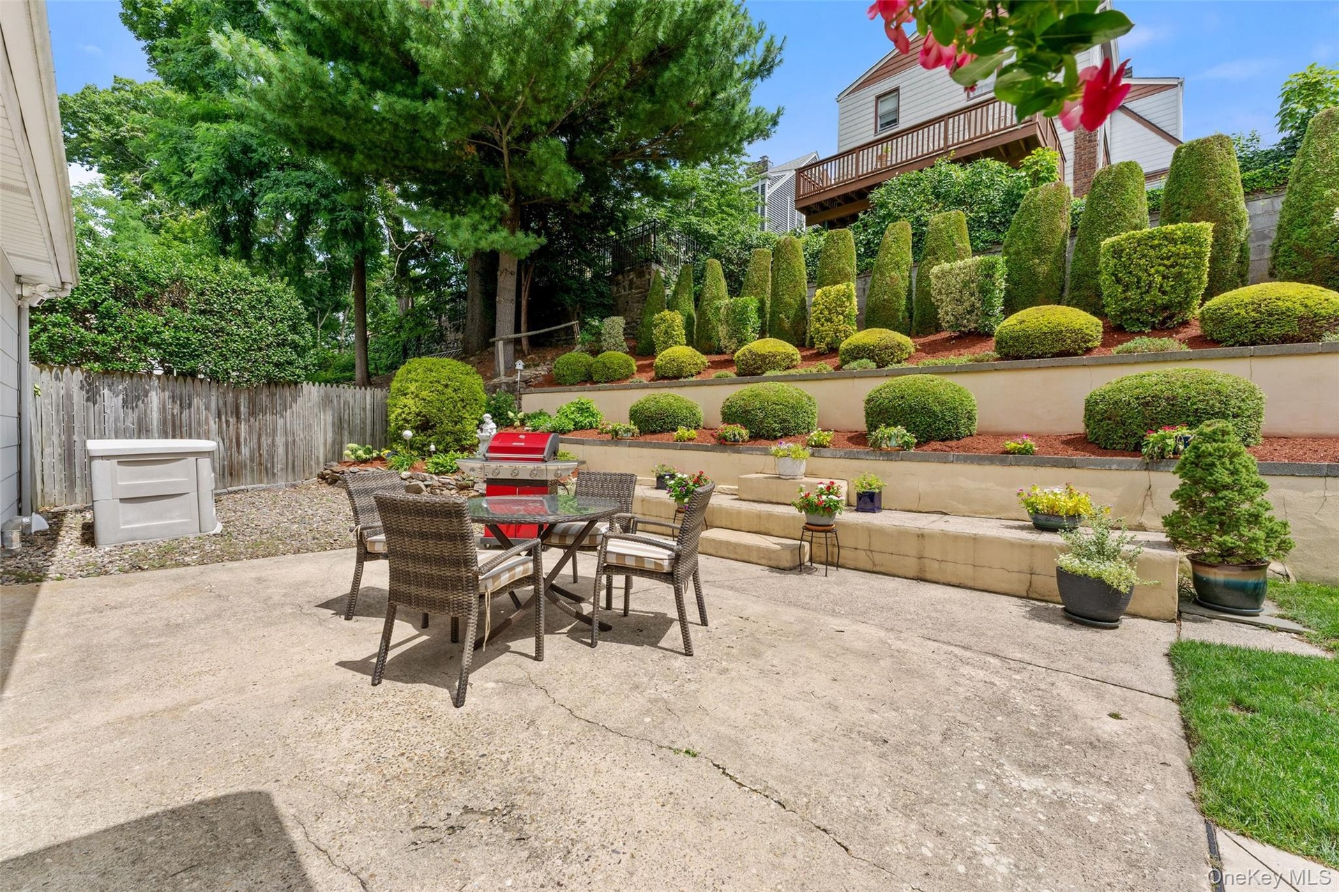 The great outdoors featuring an expansive patio and beautifully landscaped garden.