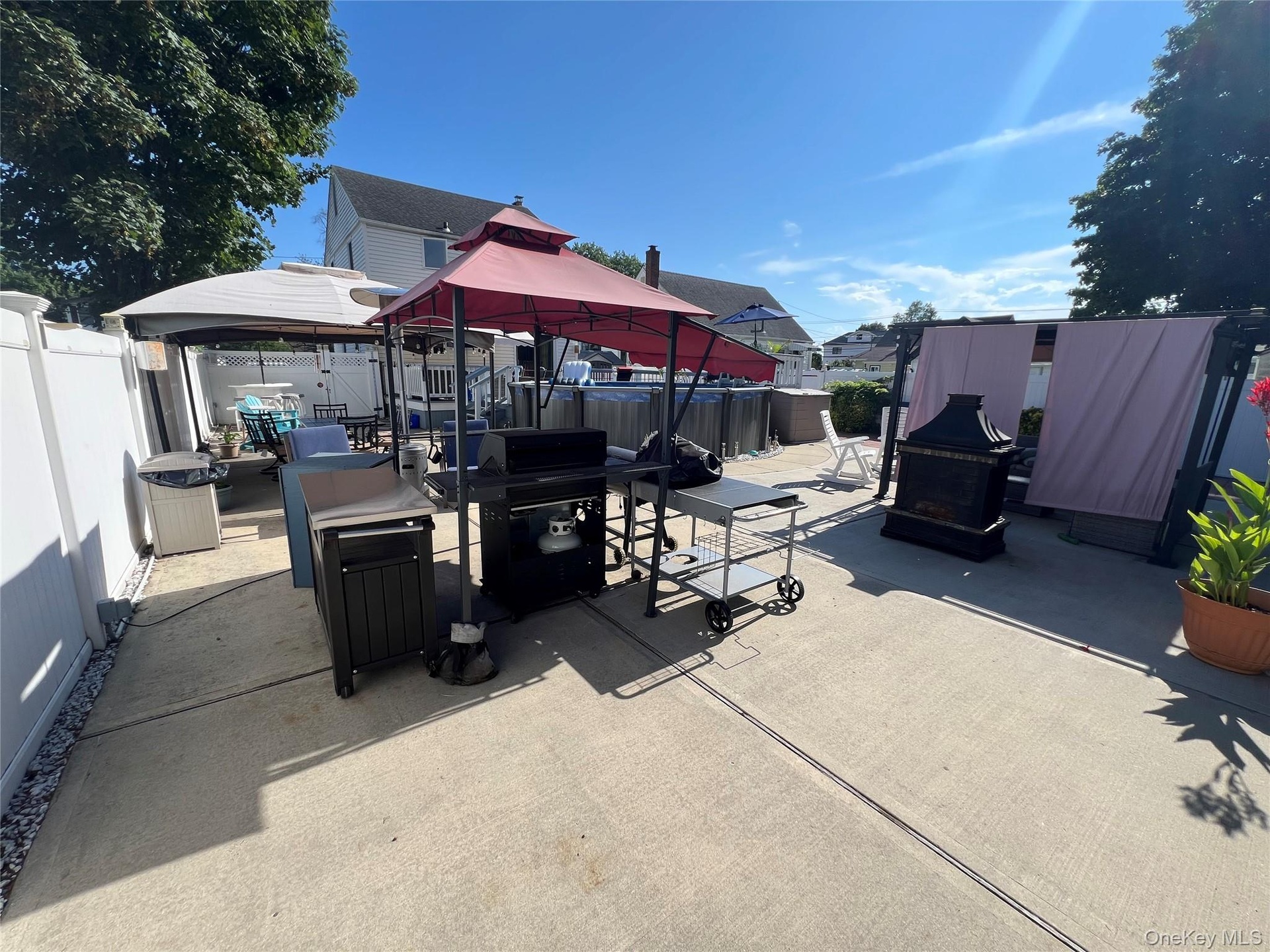 Paved patio area with a privacy fence