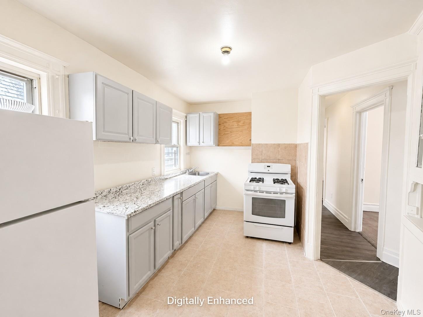 2nd fl Kitchen featuring light-toned cabinetry, a gas range, a white refrigerator, light-toned countertops, and a tiled floor