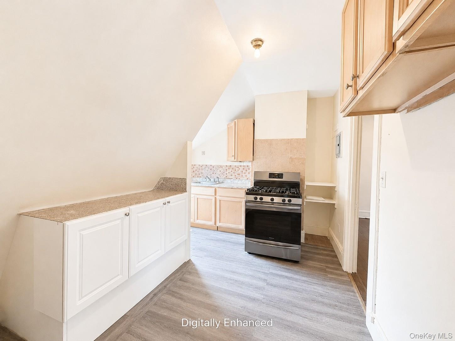 3rd fl kitchen featuring wood-finish flooring and light wood-tone cabinetry