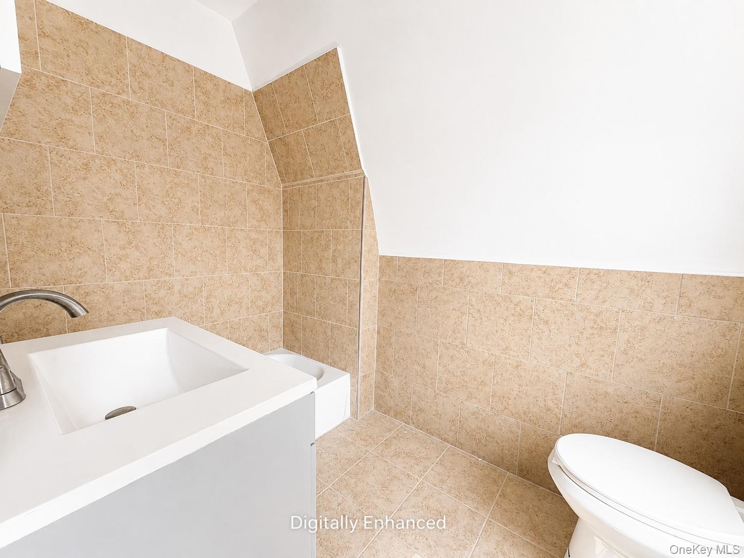 3rd fl Integrated vanity with a rectangular basin sink and a single-handle faucet
