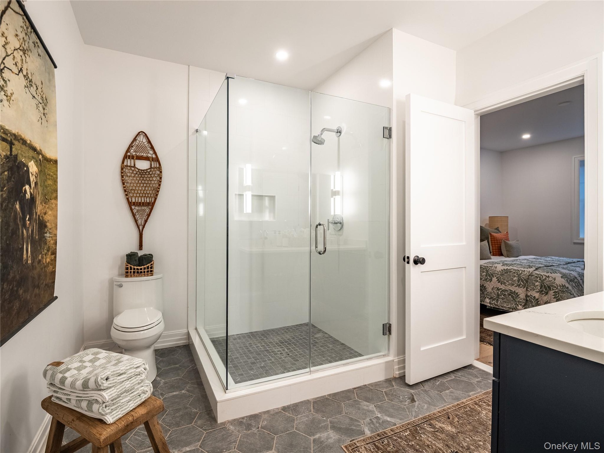Ensuite bathroom featuring vanity and a shower stall