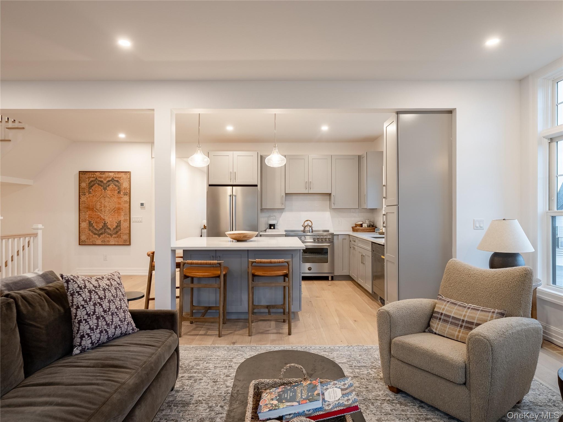 Living room with light wood-type flooring and recessed lighting