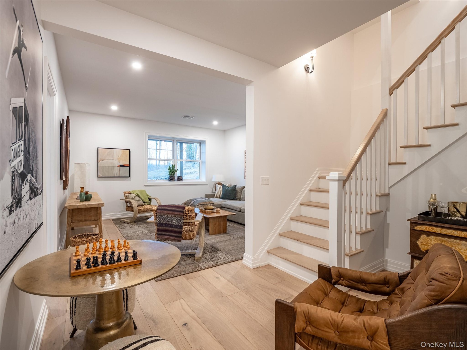 Living area featuring stairs, light wood-style floors, and recessed lighting