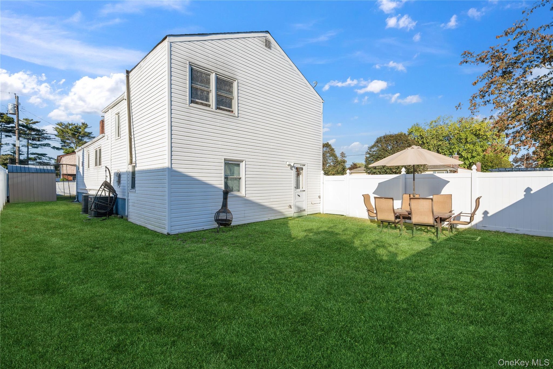 Rear view of house featuring a fenced backyard
