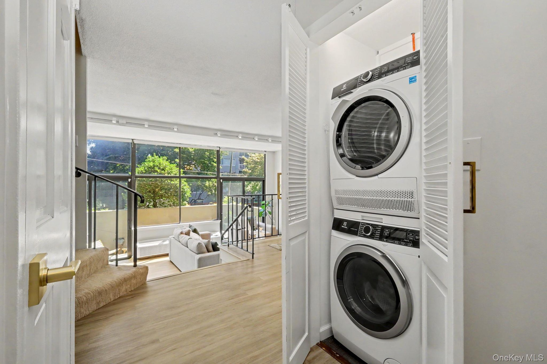 A conveniently located laundry closet off the foyer provides the ease and practicality of in-unit laundry while remaining discreetly tucked away.