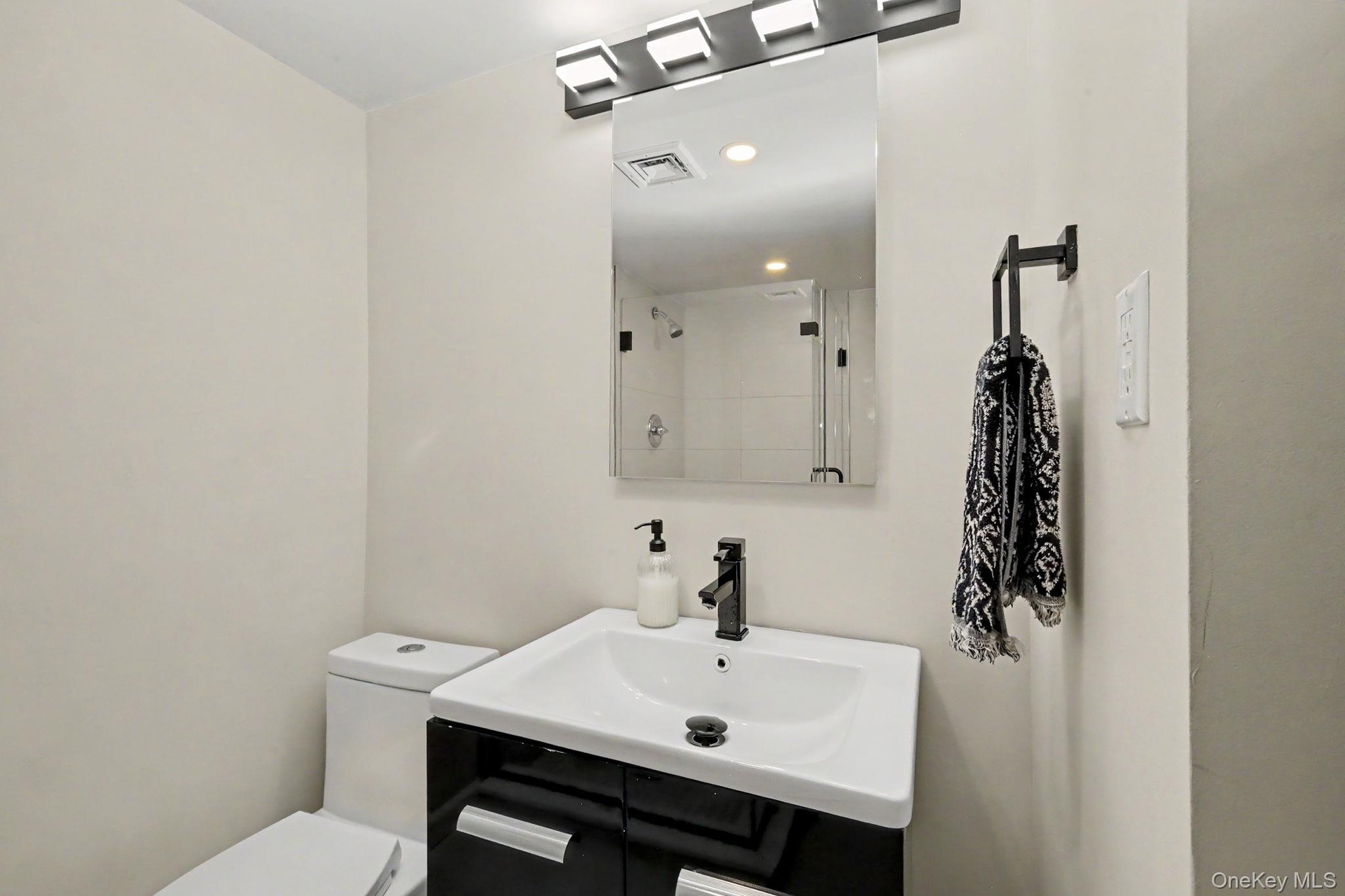 Sleek glass shower doors, designer lighting, and an elegant statement mirror, creating a polished and serene space to begin and end the day.