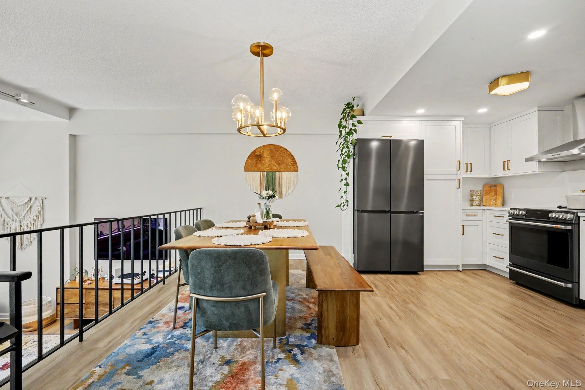 The dining area opens seamlessly to a beautifully appointed kitchen while overlooking the dramatic step-down living room, creating an open, airy layou