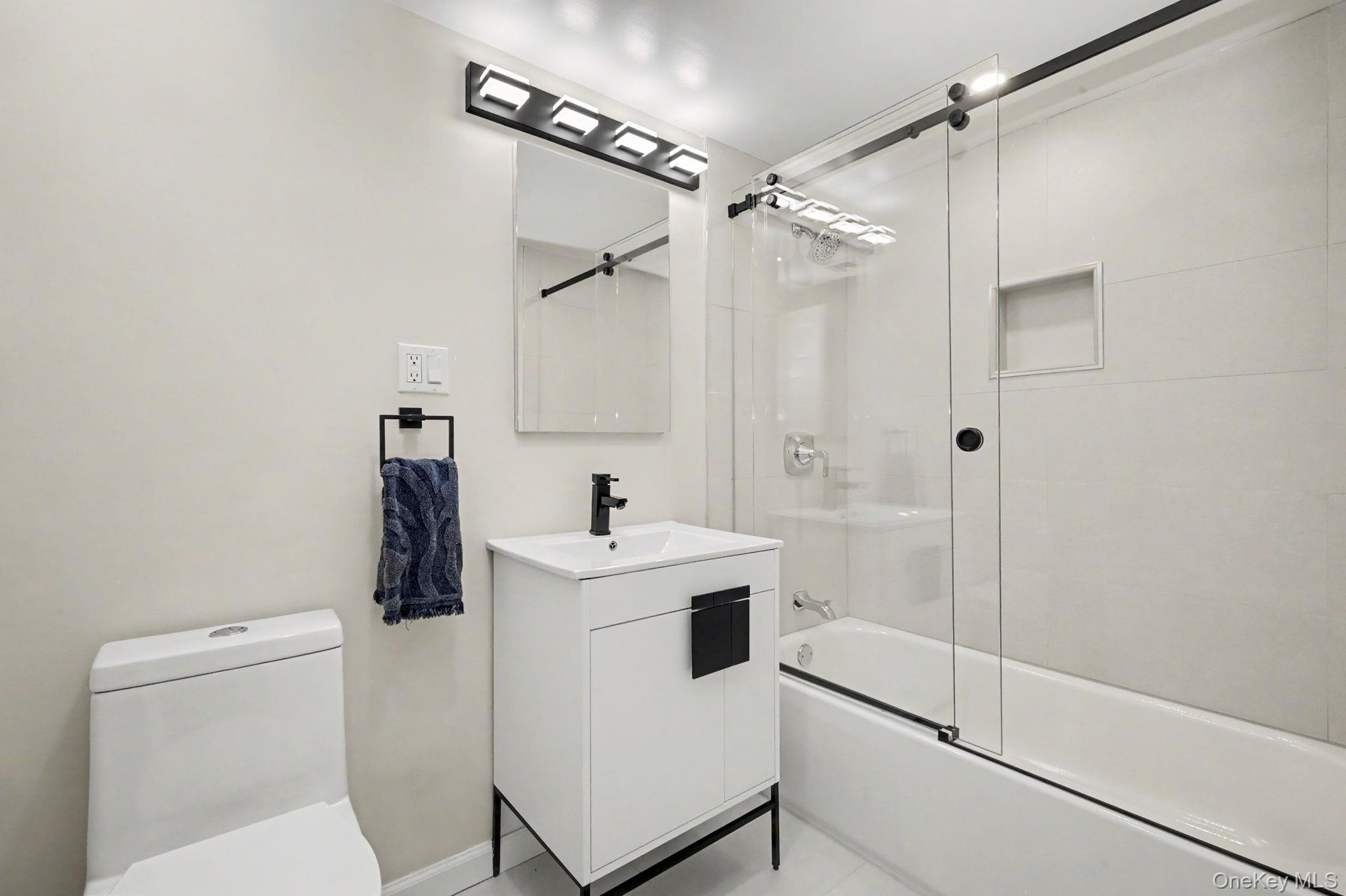 The newly renovated hall bathroom showcases thoughtfully selected designer finishes, creating a fresh, sophisticated space with a polished contemporar