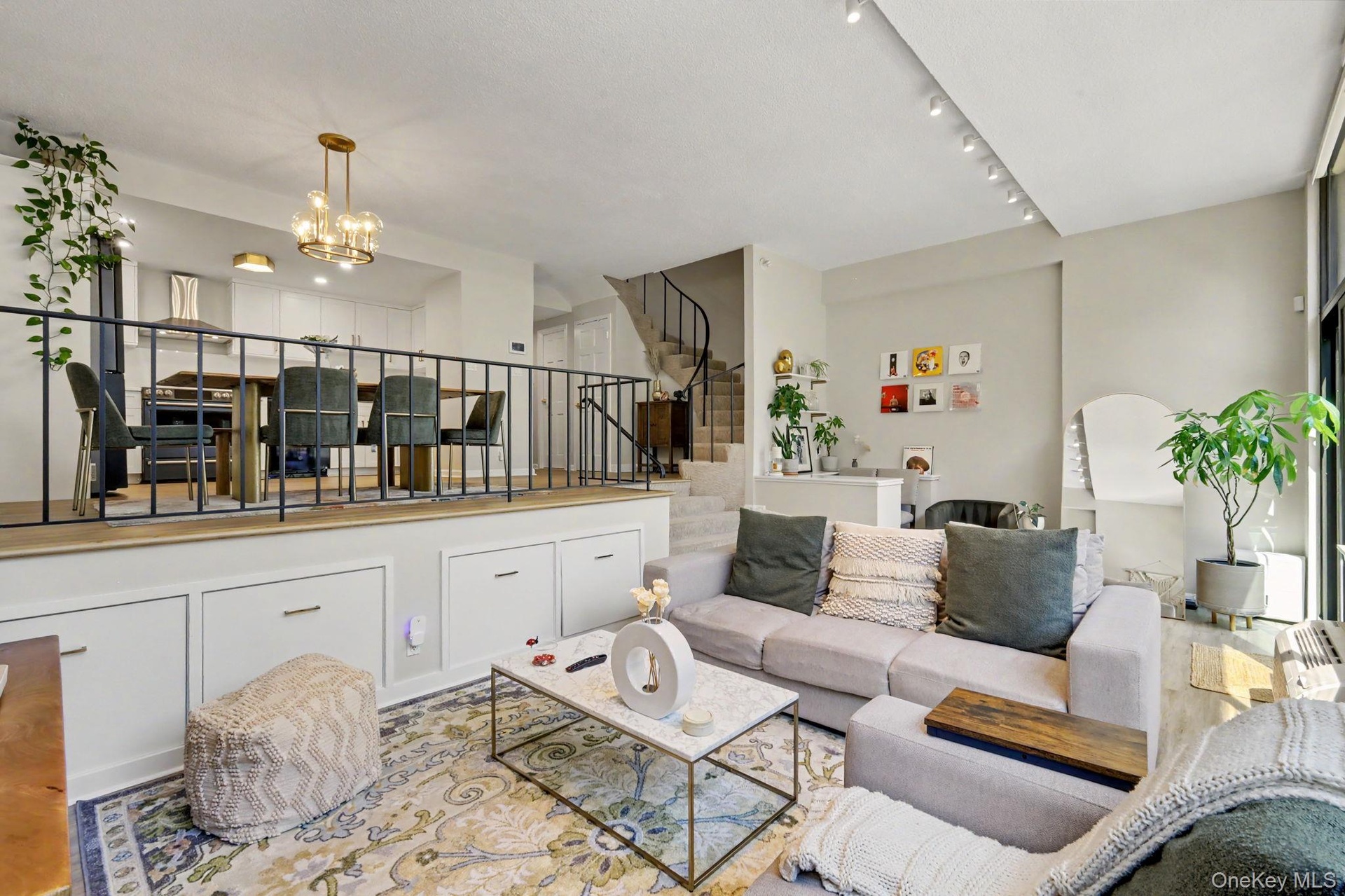 Custom built-in storage extends along the wall, providing both style and exceptional functionality, while electronically controlled window shades offe