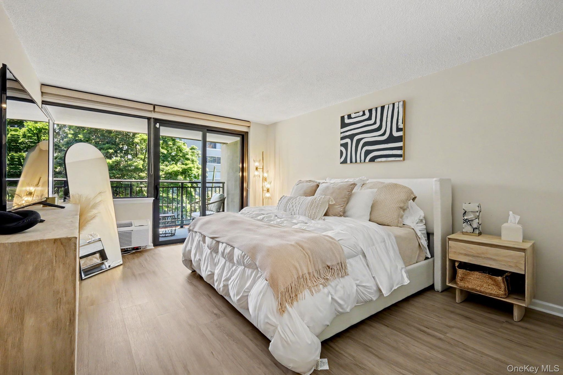 A spacious and beautifully bright bedroom is filled with abundant natural light, creating an airy, peaceful retreat.