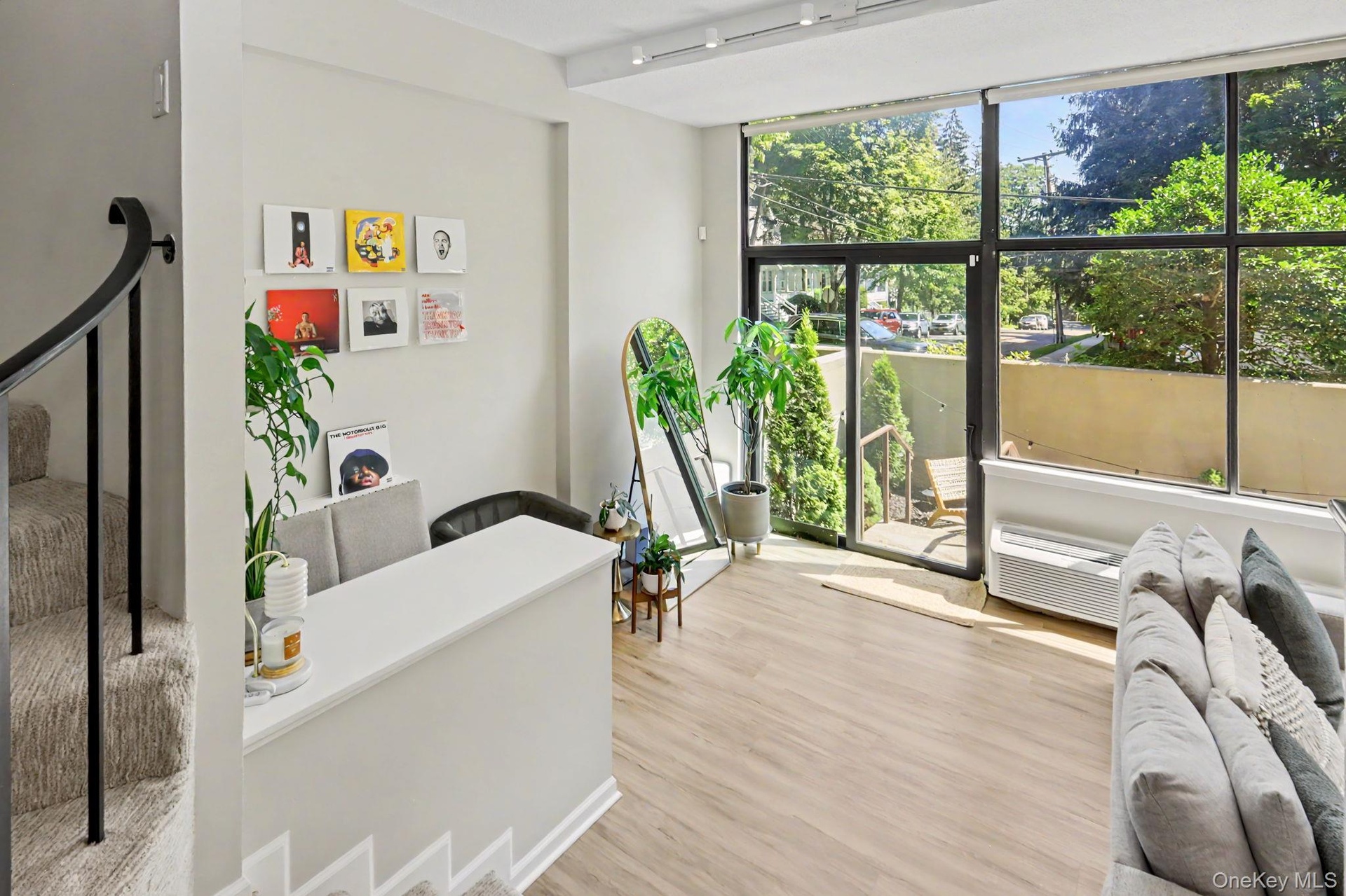 Two sets of glass doors open directly to the private terrace, creating a seamless connection between indoor and outdoor living.