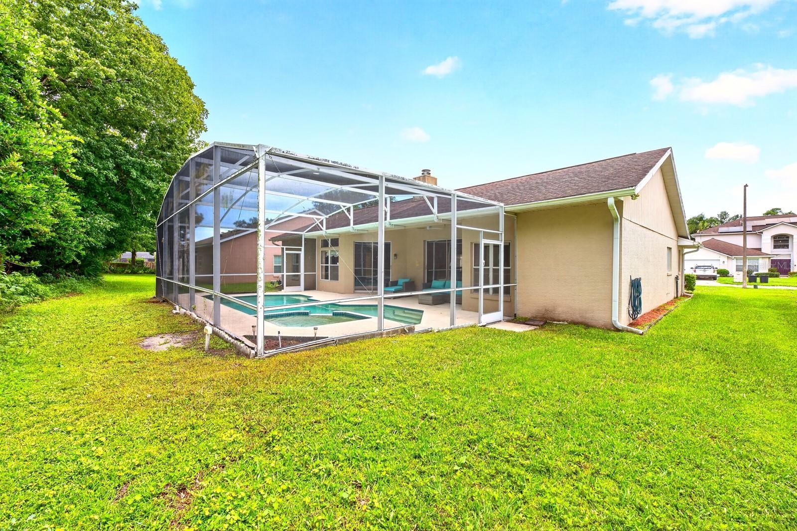 The expansive backyard is perfect for gatherings and weekend barbecues