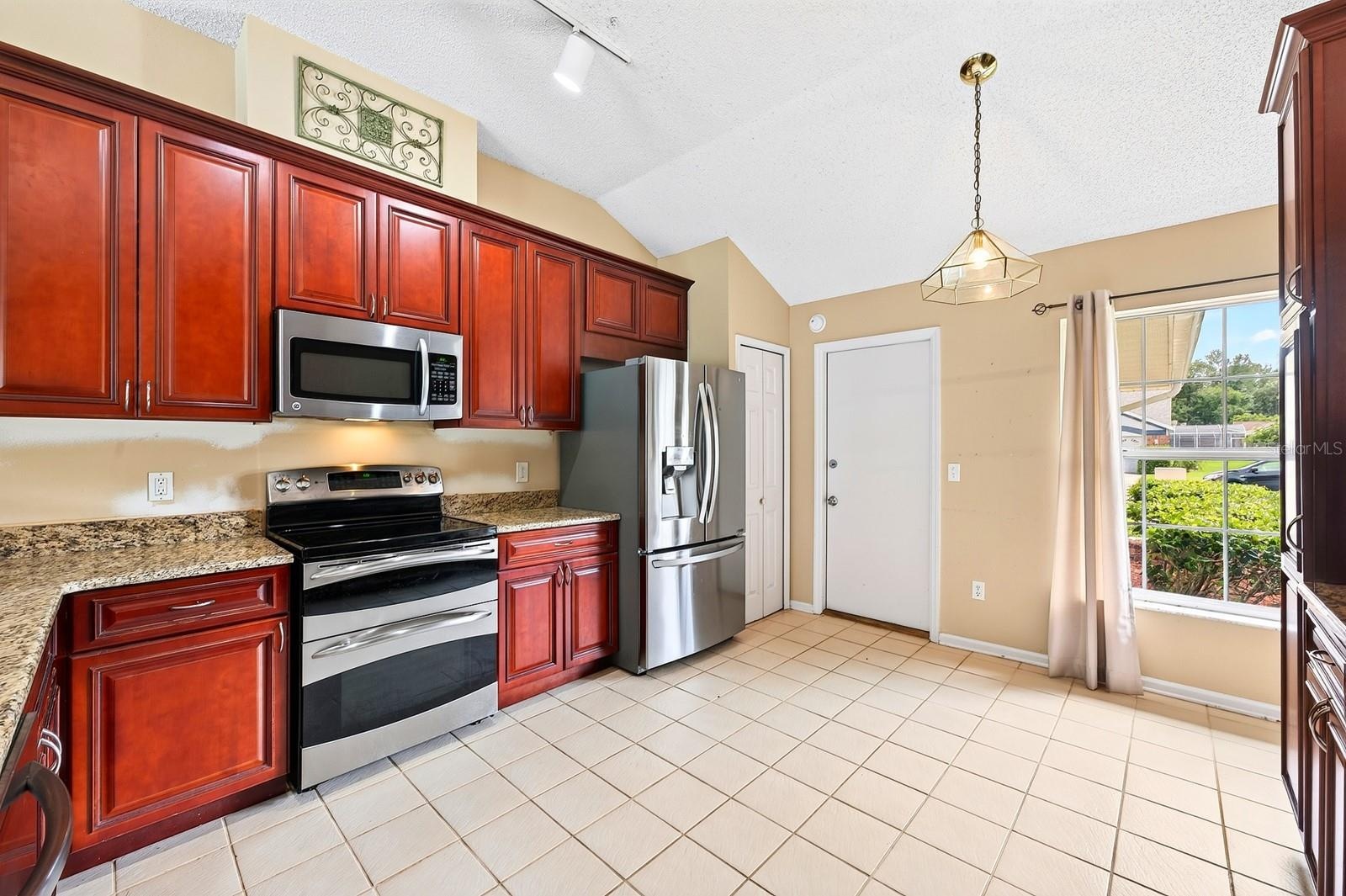 The Kitchen overlooks the Family Room and is ready for the home chef with NEW STAINLESS STEEL APPLIANCES, granite countertops, an abundance of wood ca