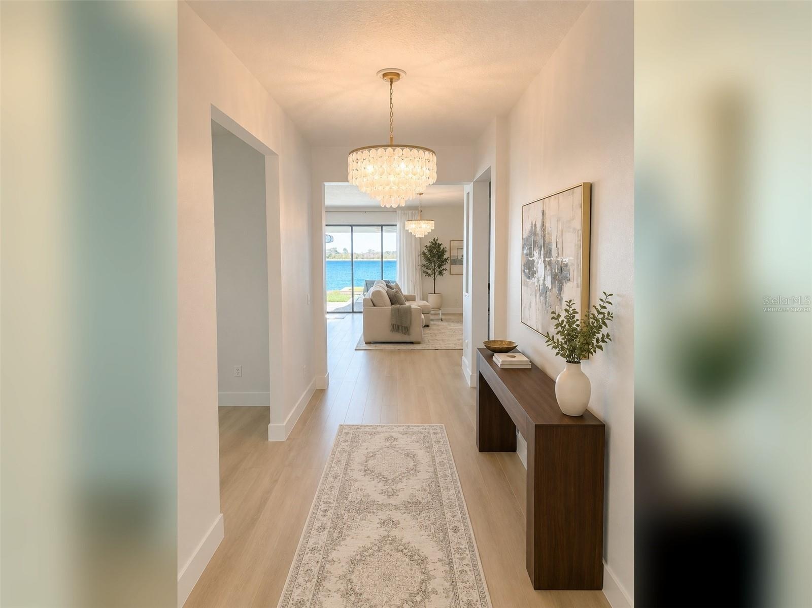 14048 Larkspur Lake Dr -Welcoming entry hallway leading into the open-concept living areas. Virtually staged.