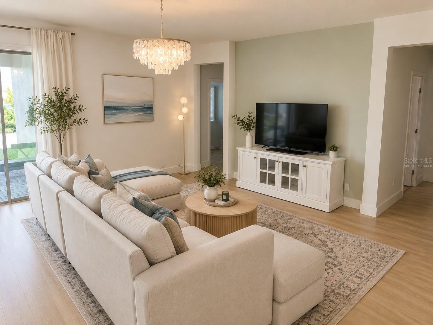 14048 Larkspur Lake Dr -Open-concept living room with a light, airy luxe coastal feel. Virtually staged.