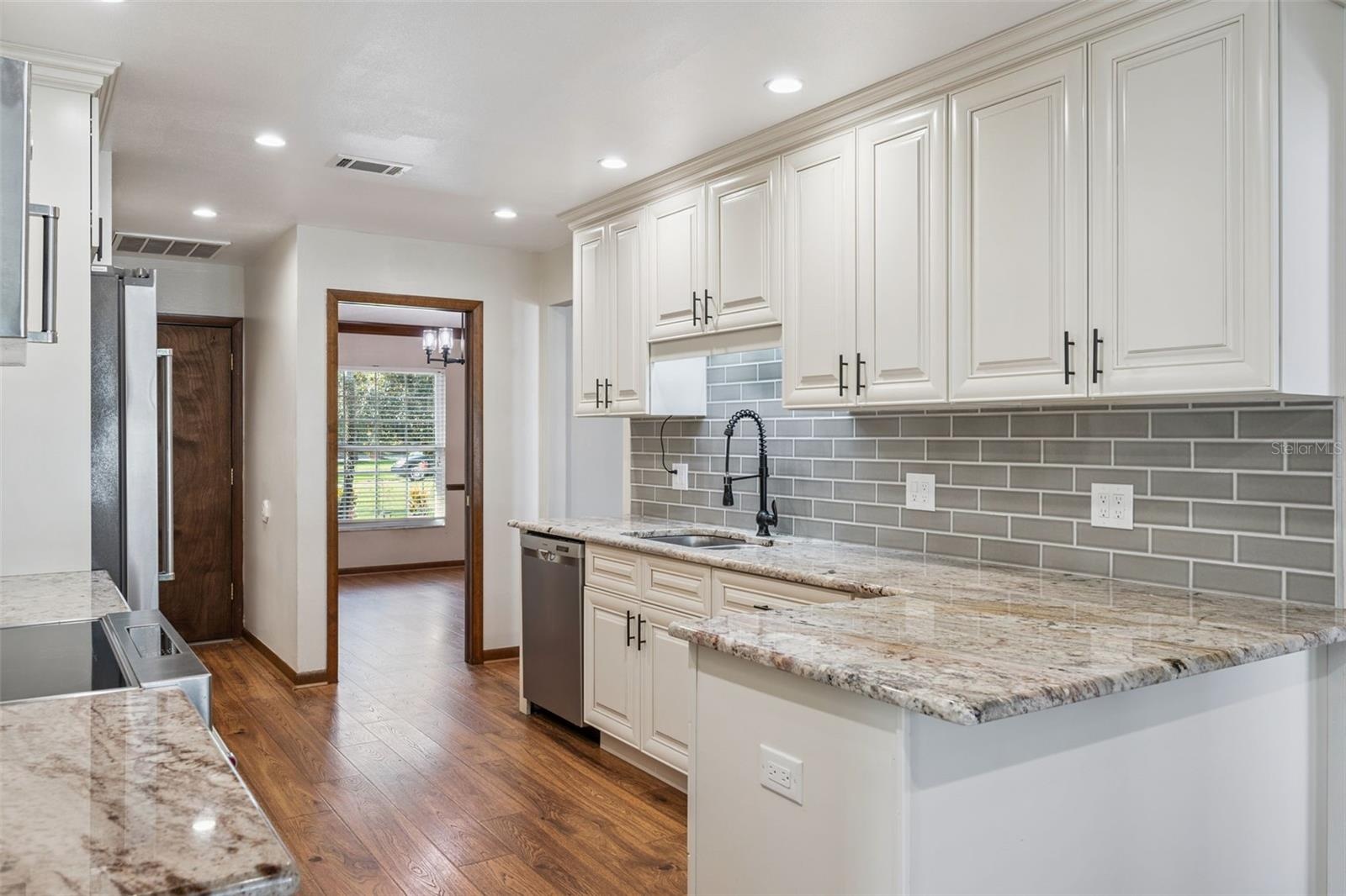 Remodeled Kitchen with Granite Countertops and Stainless Steel Appliances