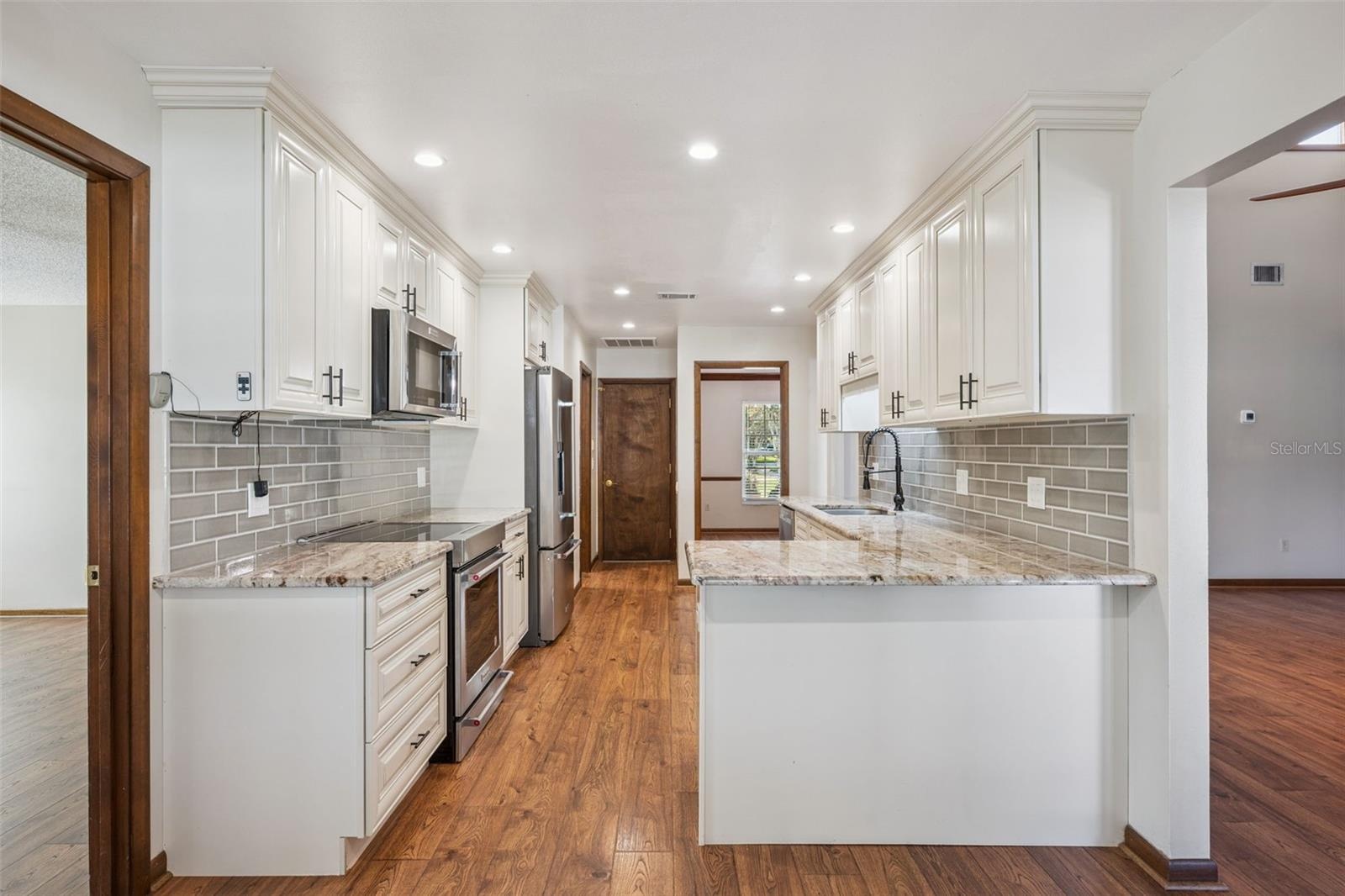 Remodeled Kitchen with Granite Countertops and Stainless Steel Appliances