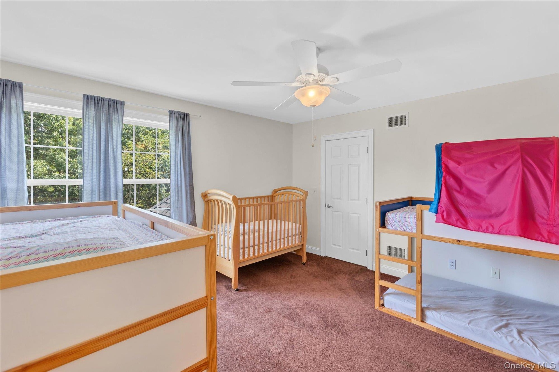 Neutral wall paint, ceiling fan with integrated lighting, brown carpet flooring, and white trim