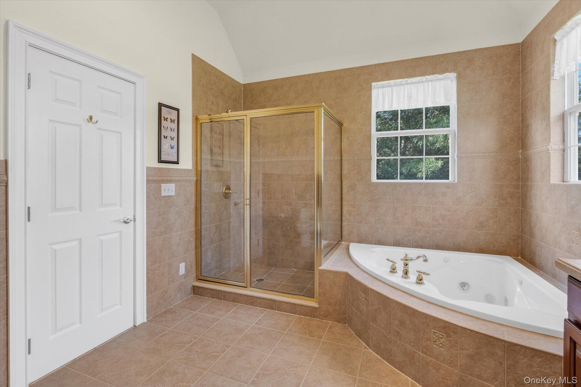 Tile flooring with a coordinating tile shower surround and tub deck