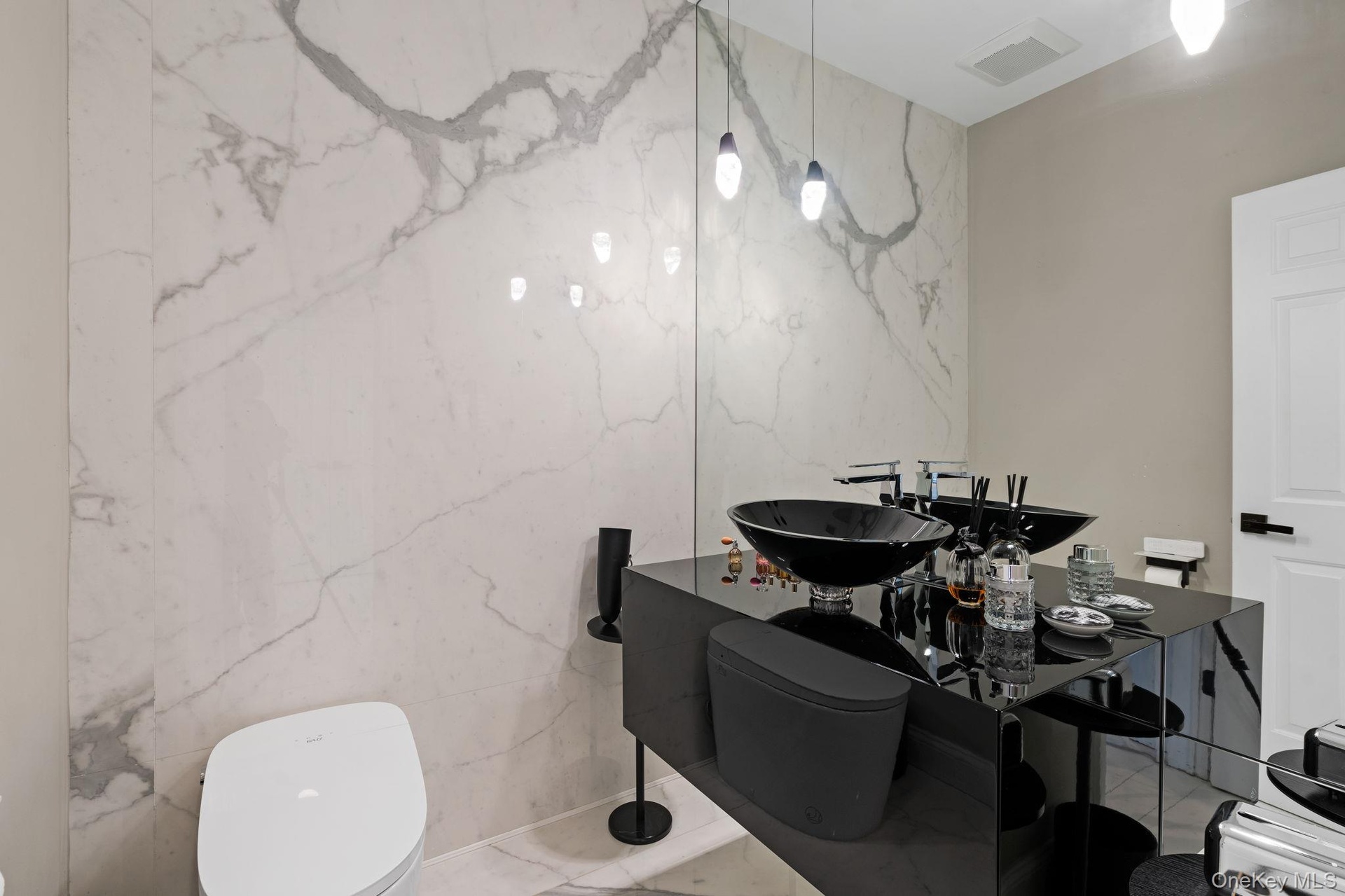 Bathroom with stone wall and marble tiled flooring