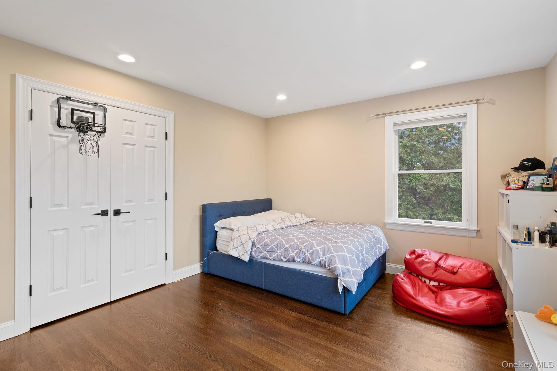 Bedroom featuring wood finished floors, recessed lighting, and a closet
