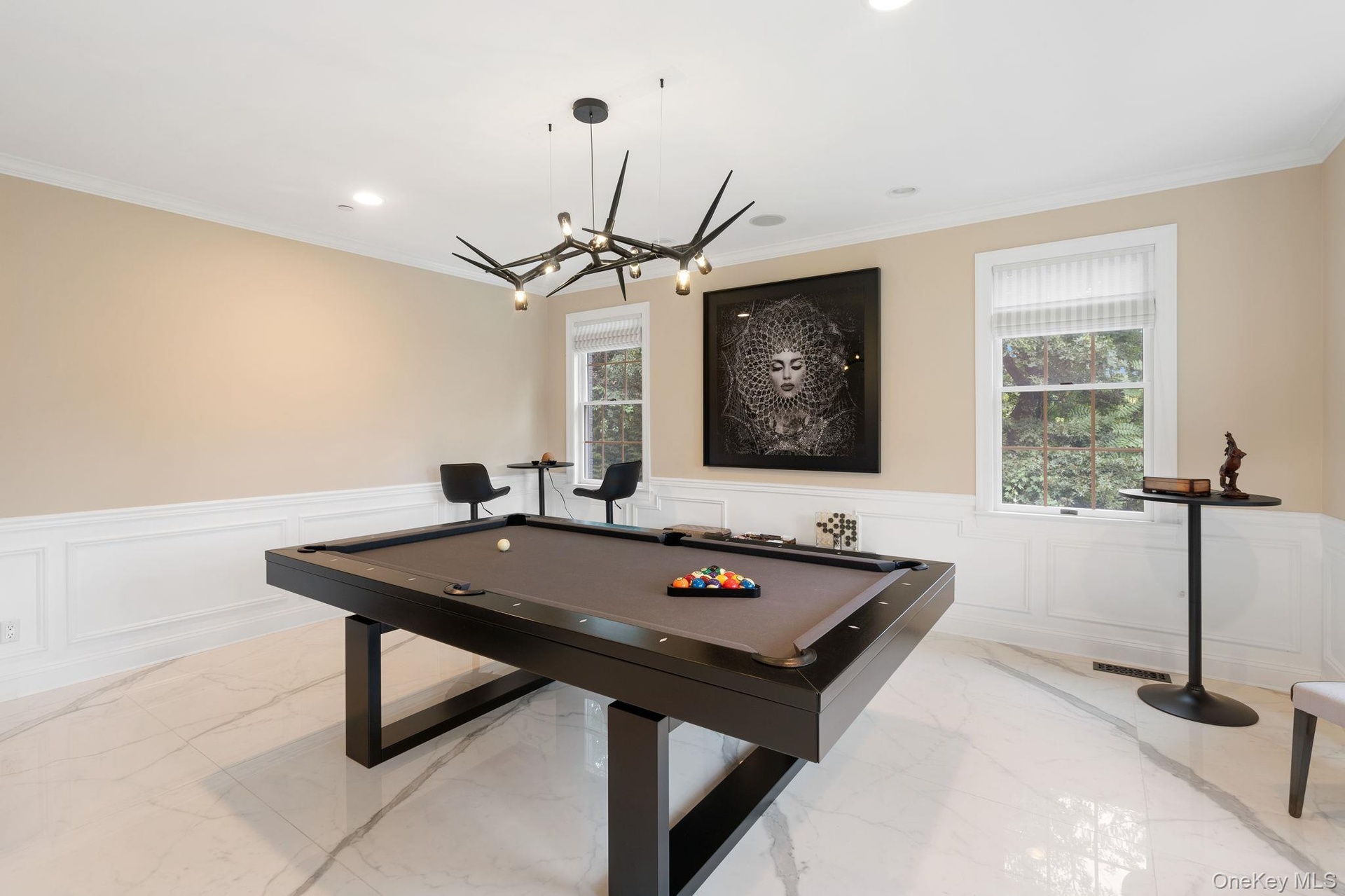 Rec room with marble tiled flooring, billiards, crown molding, a wainscoted wall, and a decorative wall
