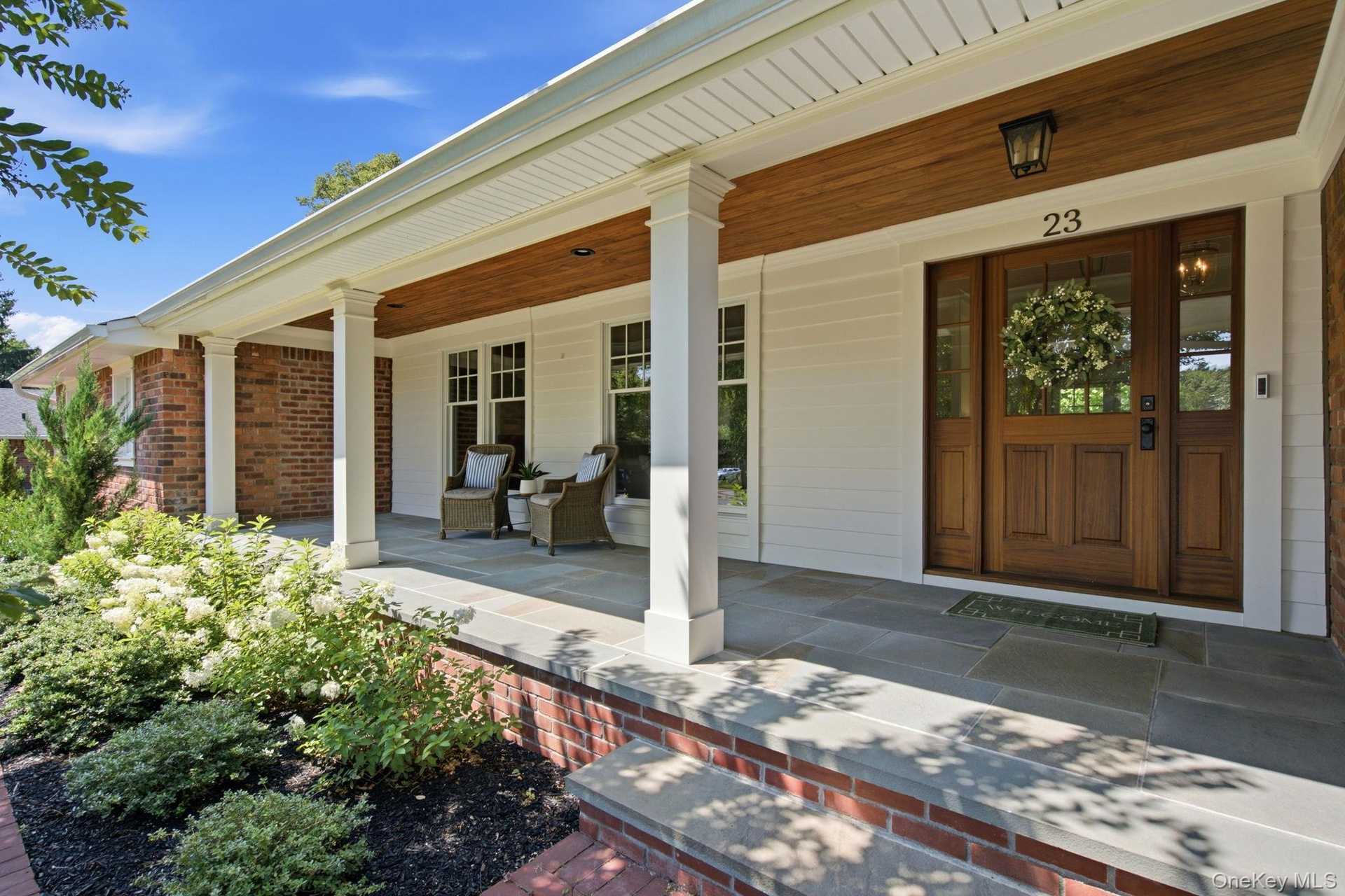Newly Renovated Covered Front Porch with Blue Stone & Mahogany Front Door .