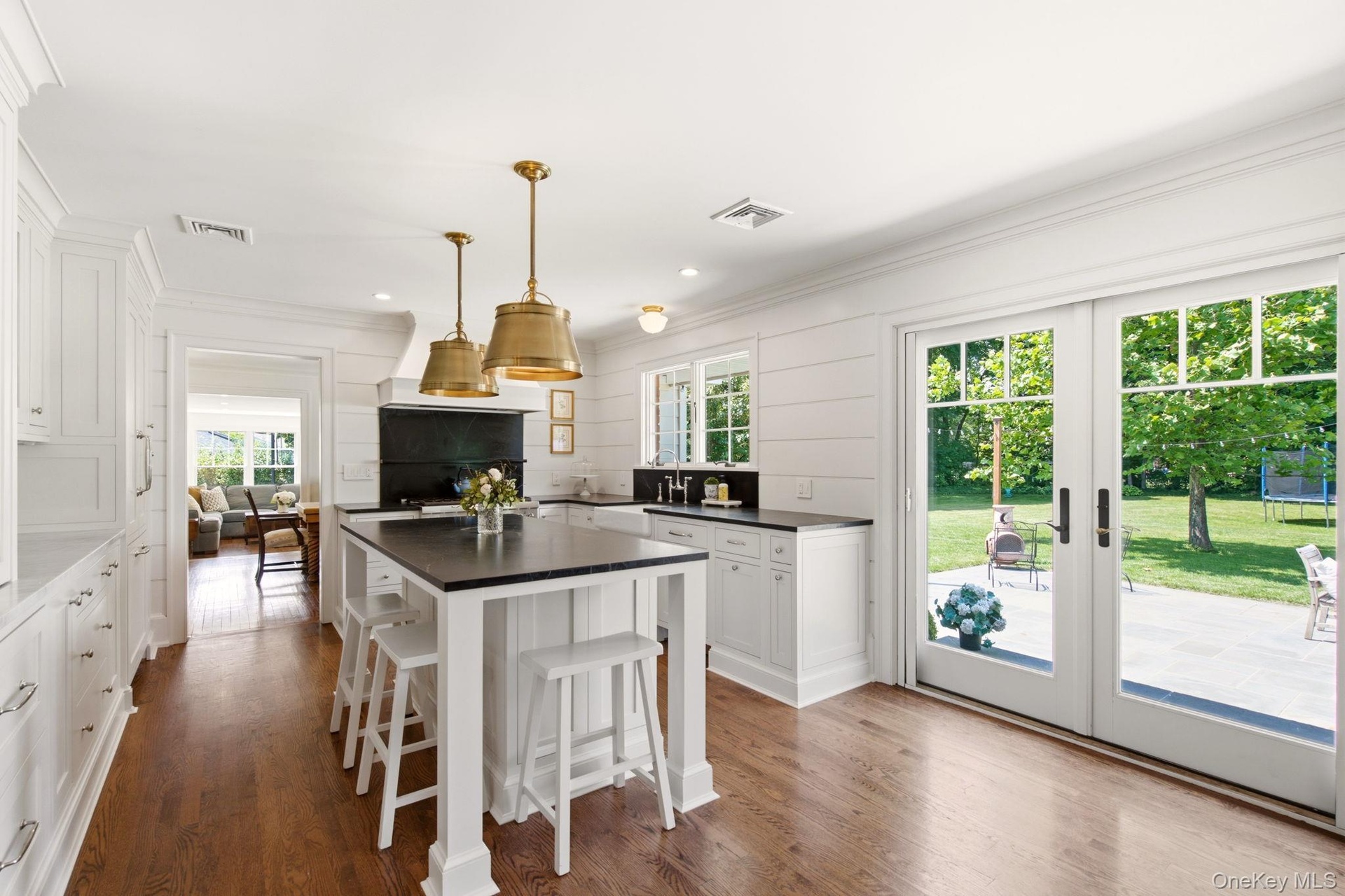 French Doors open to the blue stone back patio.