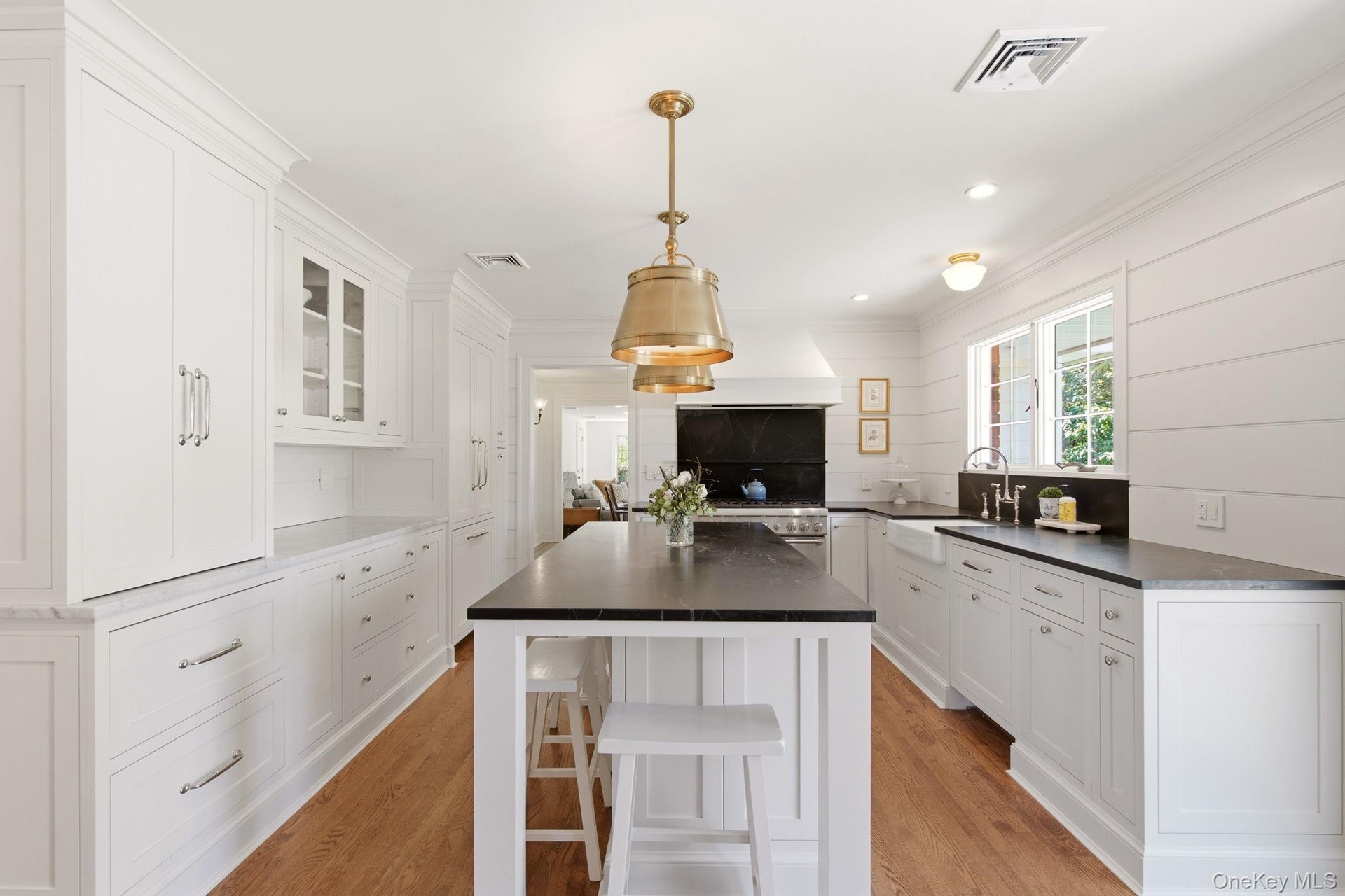 Custom Cabinetry, Nantucket style beadboard wide planked paneling and paneled covered appliances.