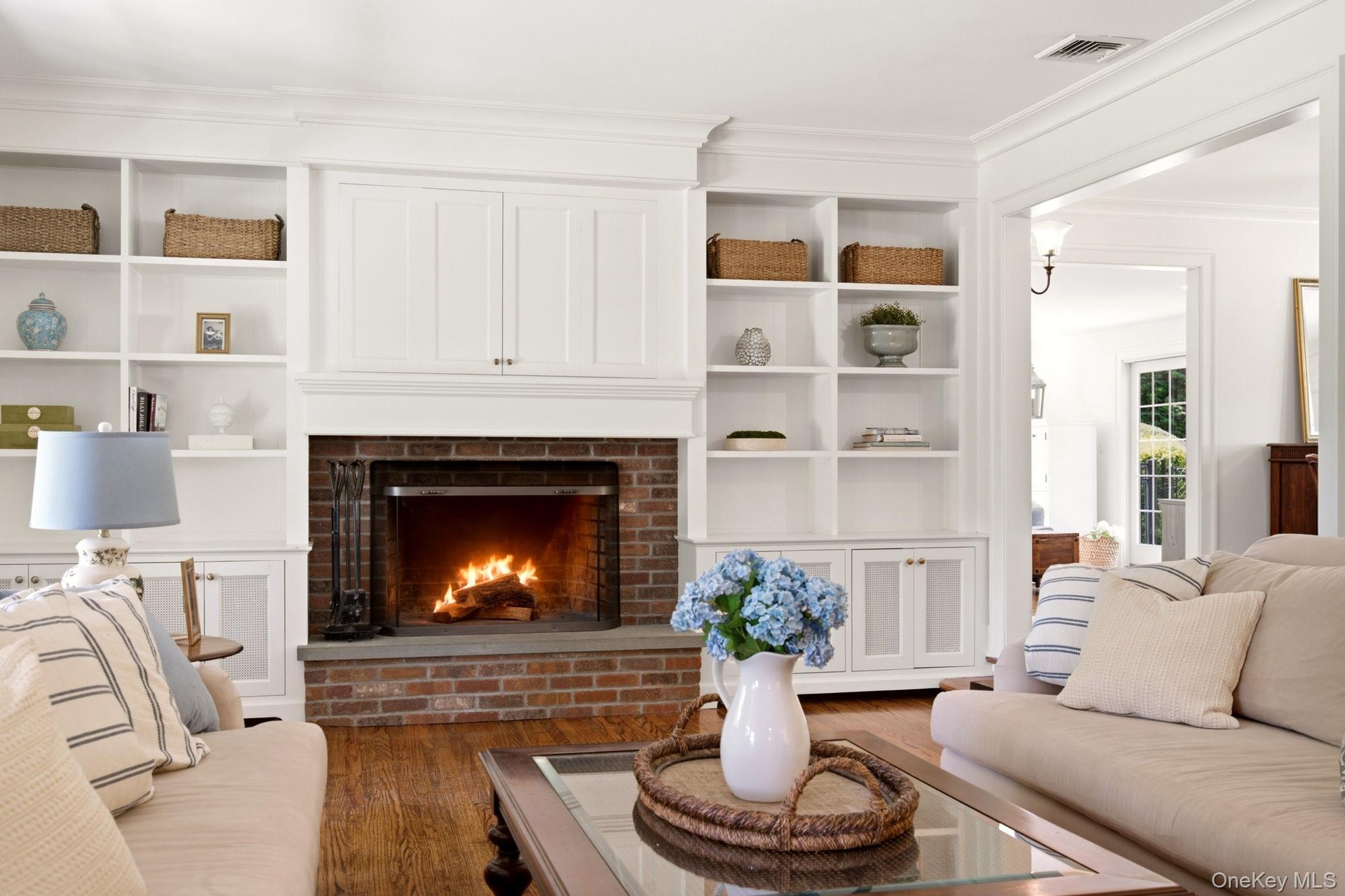 Wood buring fireplace and custom built-in cabinetry are the rooms focal point.