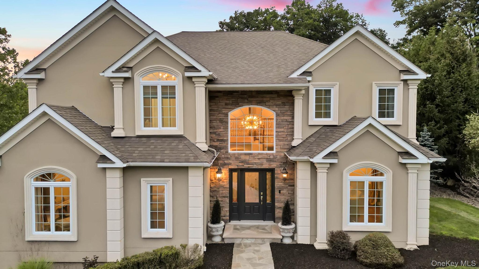 Beautiful detailing as seen with multiple angles cutouts oversized windows and lovely entry