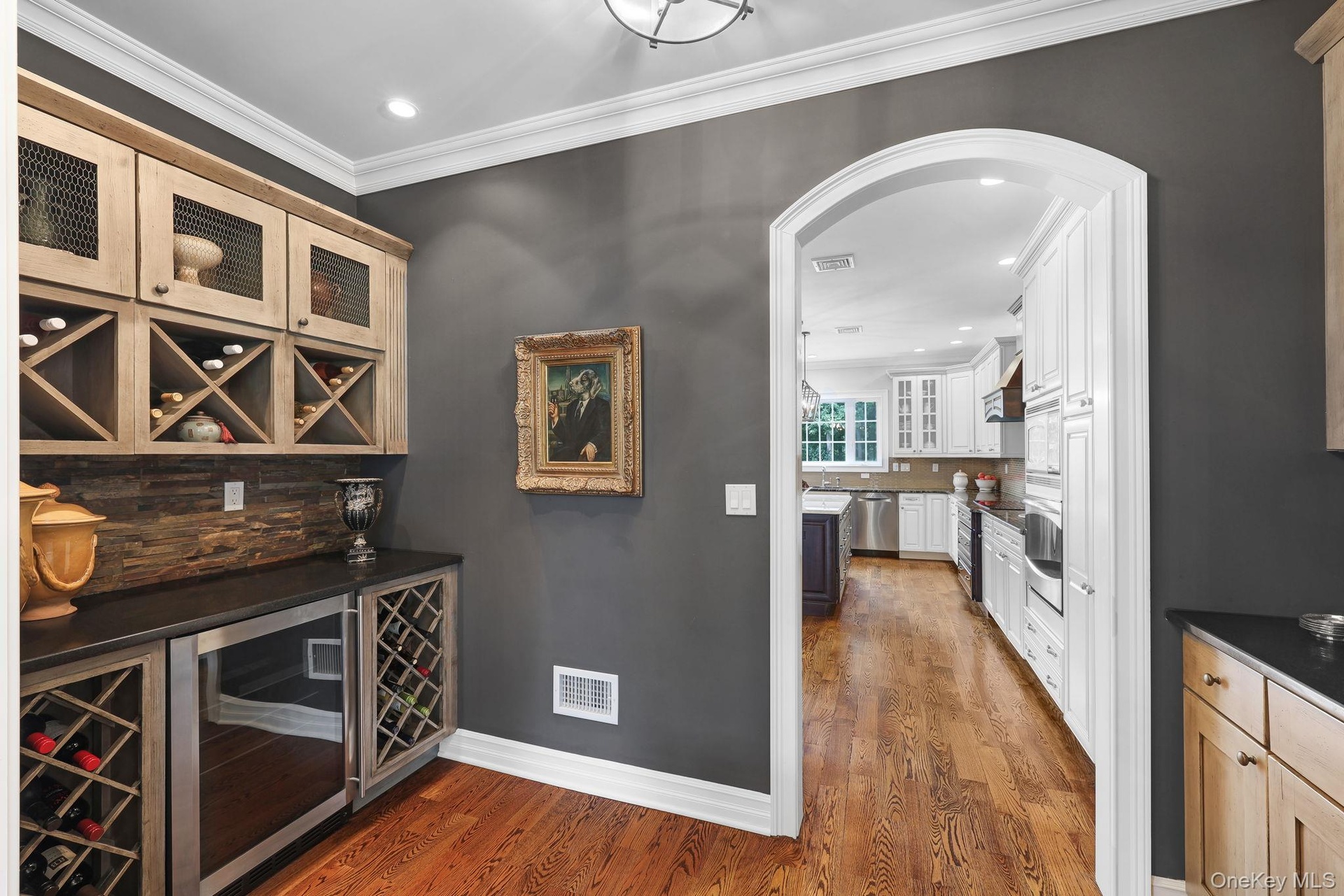 Butler's pantry with wine storage and fridge between kitchen/dining room