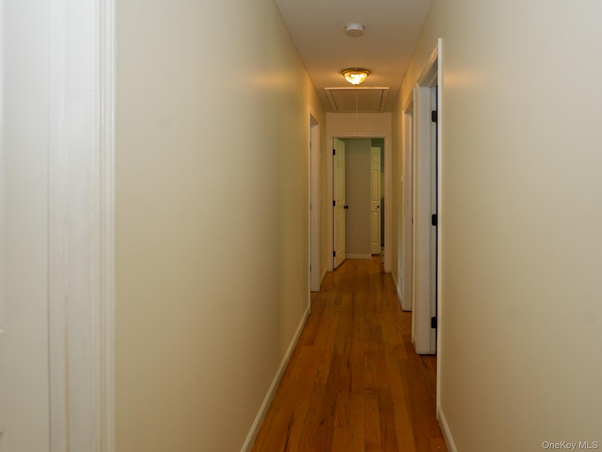 Upstairs hallway leading to full bathroom and four bedrooms