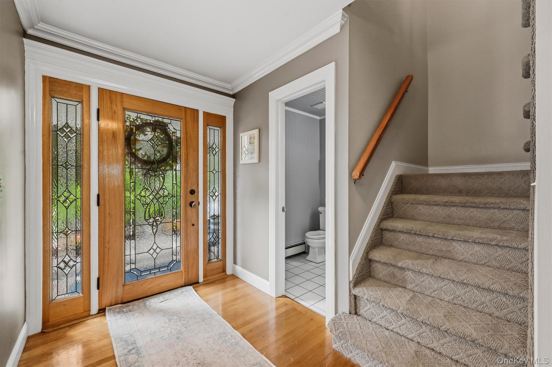 Hardwood floors, crown molding, a solid cherry door and that's just the foyer!