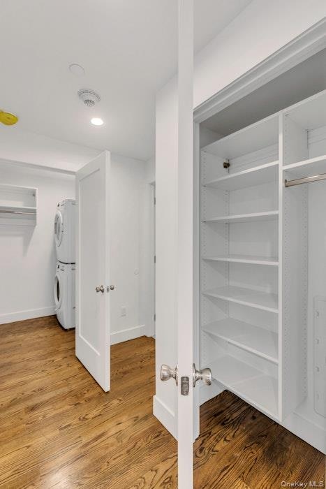 Closet featuring stacked washer/dryer and built-ins